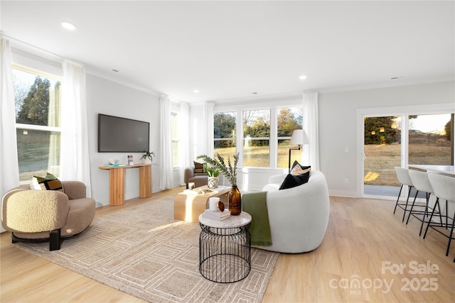 living area featuring light wood-style floors, a wealth of natural light, and recessed lighting