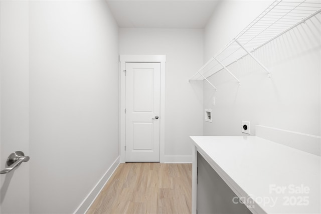 laundry area with laundry area, light wood finished floors, baseboards, hookup for an electric dryer, and washer hookup