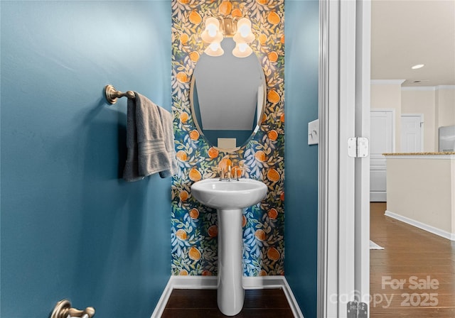 bathroom featuring ornamental molding and hardwood / wood-style floors