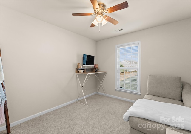 living area with light colored carpet and ceiling fan