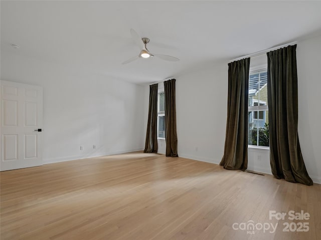 unfurnished room with ceiling fan and light wood-type flooring