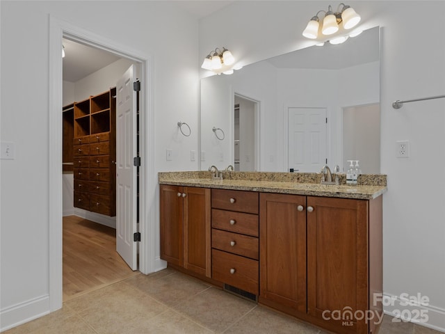 bathroom featuring vanity, tile patterned floors, and a chandelier