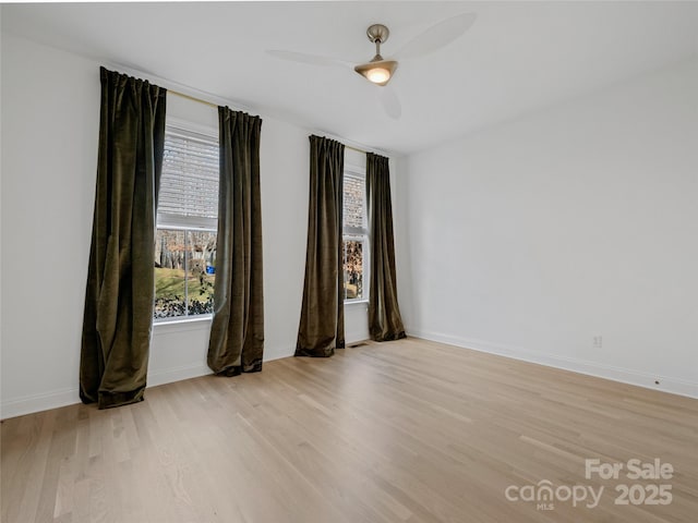 spare room featuring ceiling fan and light hardwood / wood-style flooring