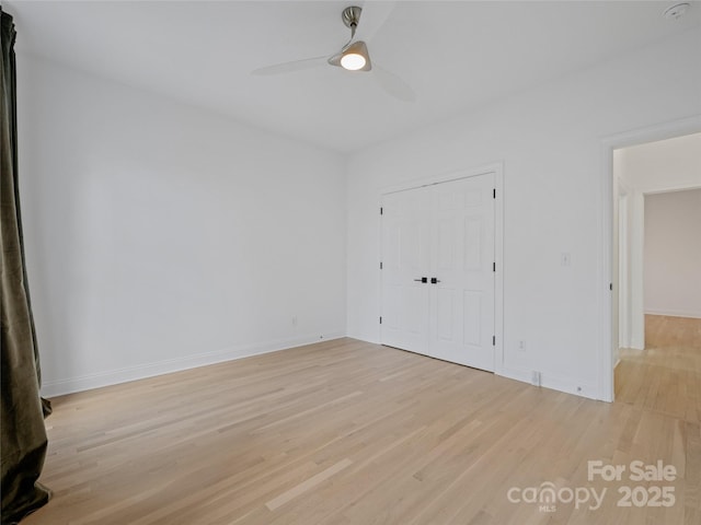 unfurnished bedroom with a closet, ceiling fan, and light hardwood / wood-style flooring