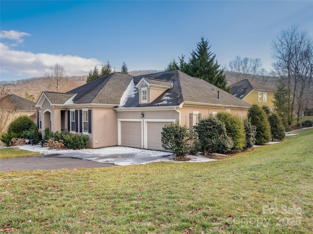 view of front of property with a front yard and a garage