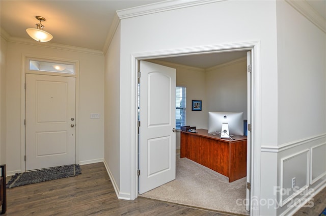 foyer with dark hardwood / wood-style flooring and ornamental molding