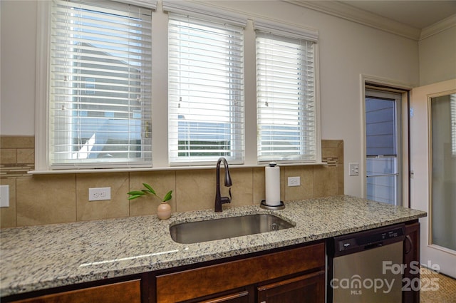 kitchen with light stone counters, ornamental molding, dark brown cabinetry, sink, and dishwasher