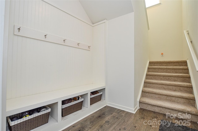 mudroom with vaulted ceiling and dark wood-type flooring