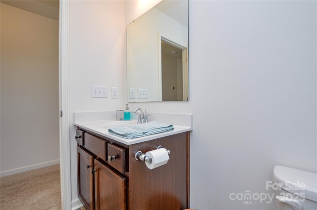 bathroom featuring vanity and toilet