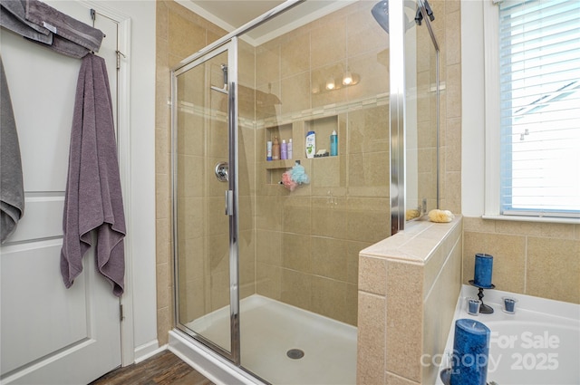 bathroom with wood-type flooring and walk in shower