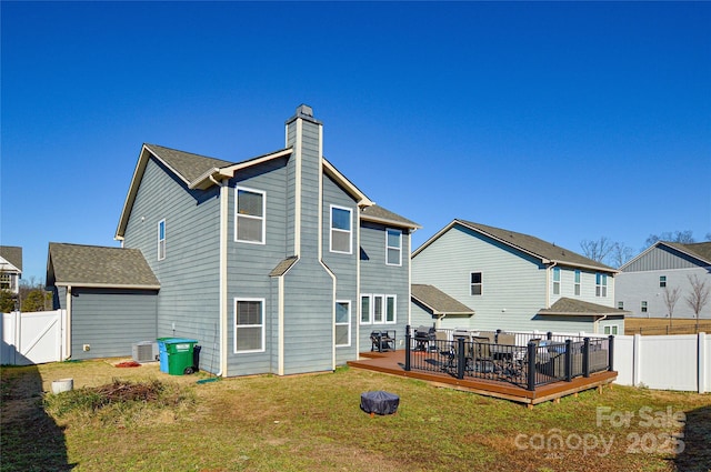 back of house featuring a yard, cooling unit, and a wooden deck