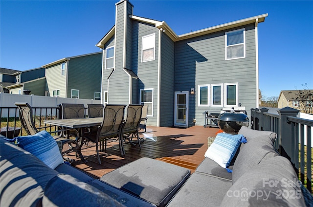 deck featuring outdoor lounge area and grilling area