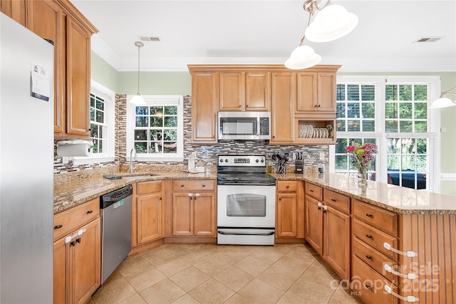 kitchen featuring sink, hanging light fixtures, kitchen peninsula, decorative backsplash, and appliances with stainless steel finishes