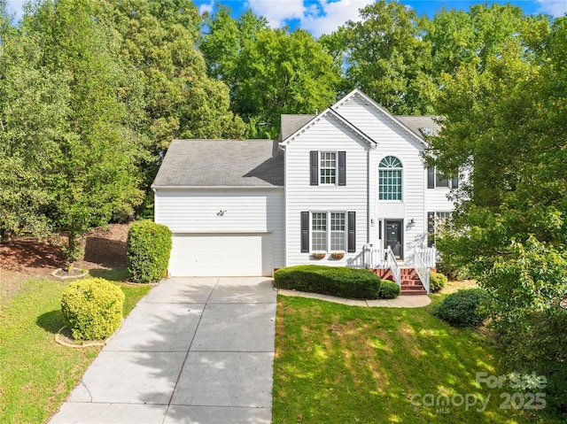 view of front of property featuring a front lawn and a garage