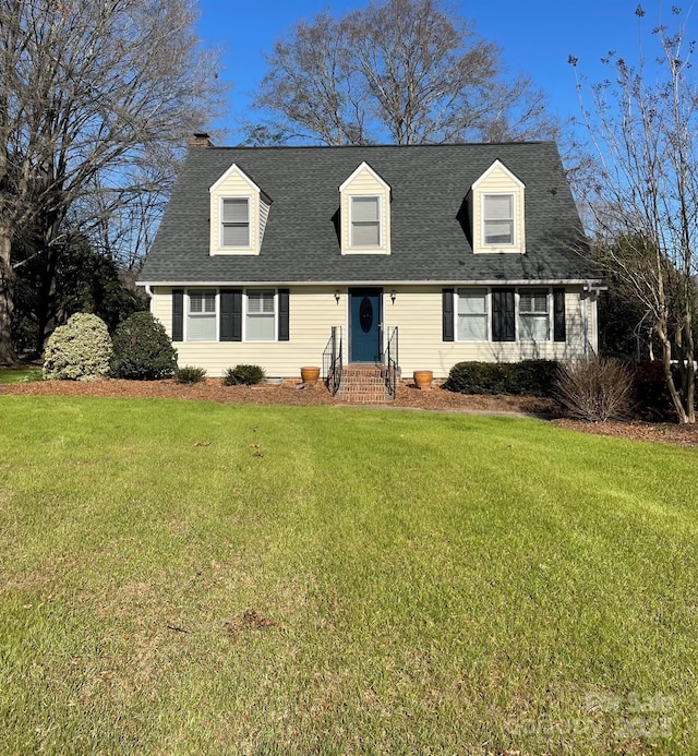 cape cod home with a front lawn