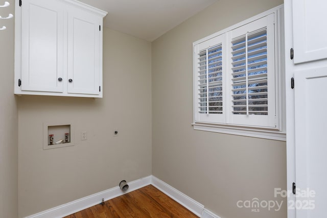 washroom with hookup for a washing machine, wood-type flooring, cabinets, and hookup for an electric dryer