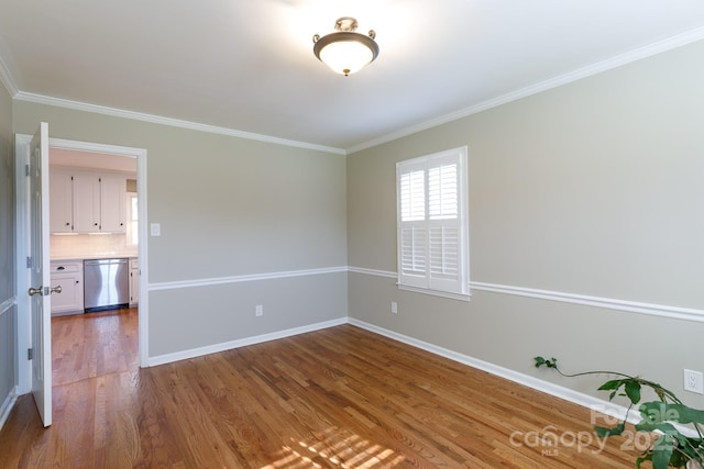 empty room featuring crown molding and hardwood / wood-style flooring