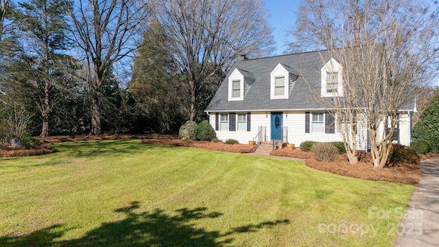 cape cod home with a front yard