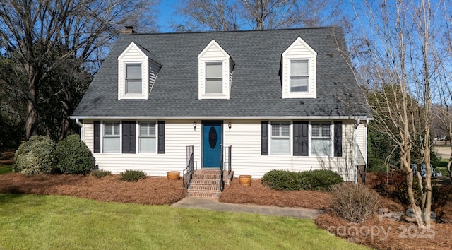 cape cod home featuring a front lawn