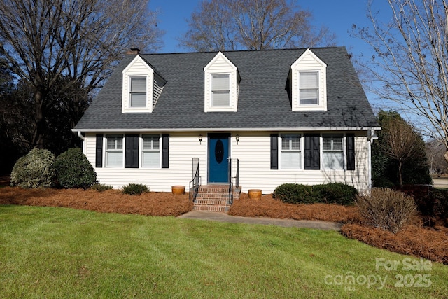 cape cod home featuring a front yard