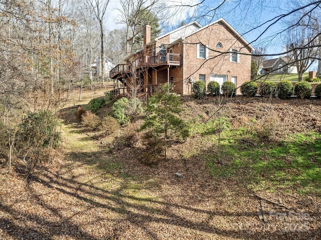 back of property featuring a wooden deck