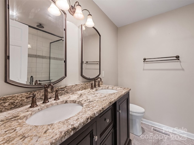 bathroom with tile patterned flooring, a shower with door, vanity, and toilet