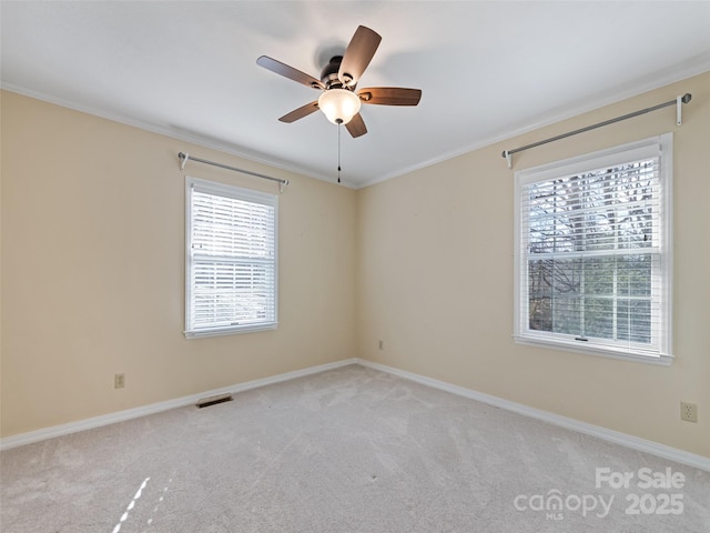 carpeted empty room with crown molding and ceiling fan