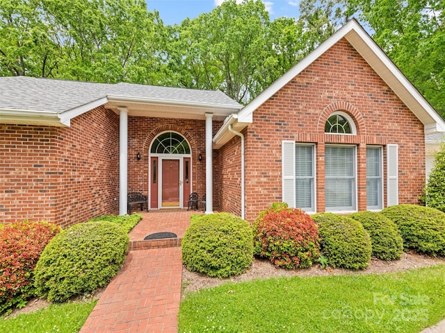 185 Oak Ridge Dr, Clyde, NC 28721 - view of exterior entry featuring brick siding and a shingled roof