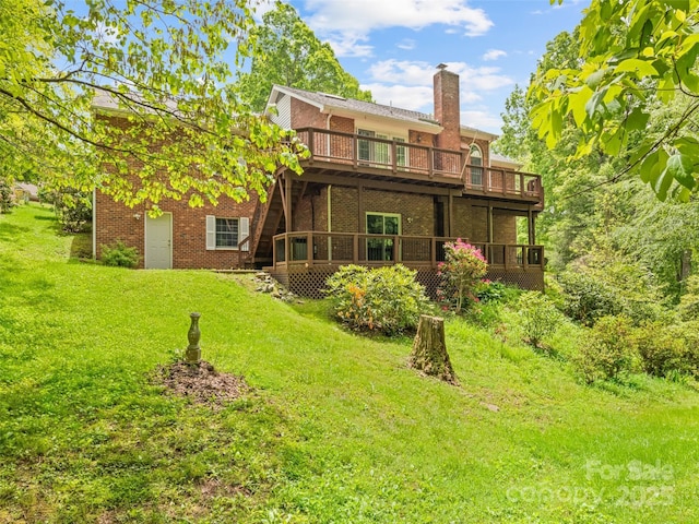 185 Oak Ridge Dr, Clyde, NC 28721 - rear view of house with a deck, brick siding, and a yard