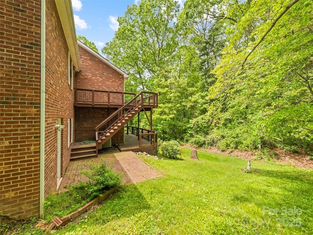 185 Oak Ridge Dr, Clyde, NC 28721 - view of grassy yard with stairs, a wooden deck, and a patio