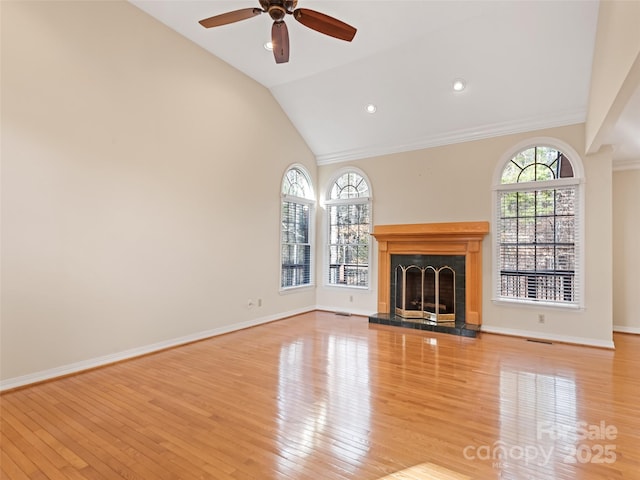 185 Oak Ridge Dr, Clyde, NC 28721 - unfurnished living room featuring wood finished floors, ceiling fan, a fireplace with raised hearth, baseboards, and crown molding