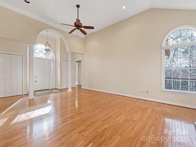 185 Oak Ridge Dr, Clyde, NC 28721 - entryway with decorative columns, arched walkways, light wood-type flooring, a ceiling fan, and high vaulted ceiling