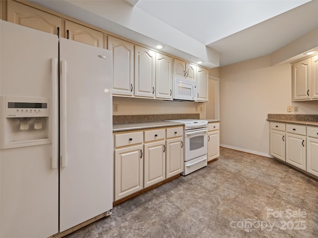 185 Oak Ridge Dr, Clyde, NC 28721 - kitchen featuring white appliances, dark countertops, and baseboards