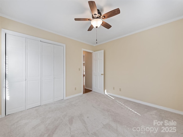 185 Oak Ridge Dr, Clyde, NC 28721 - unfurnished bedroom with crown molding, light colored carpet, a closet, baseboards, and ceiling fan