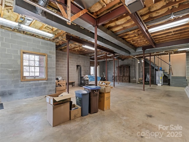 185 Oak Ridge Dr, Clyde, NC 28721 - below grade area with gas water heater, stairs, and concrete block wall
