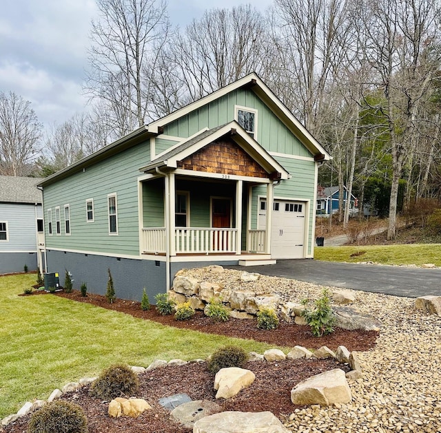 view of front of house featuring central AC unit, a porch, and a garage