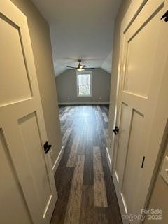 bonus room featuring ceiling fan, dark wood-type flooring, and vaulted ceiling