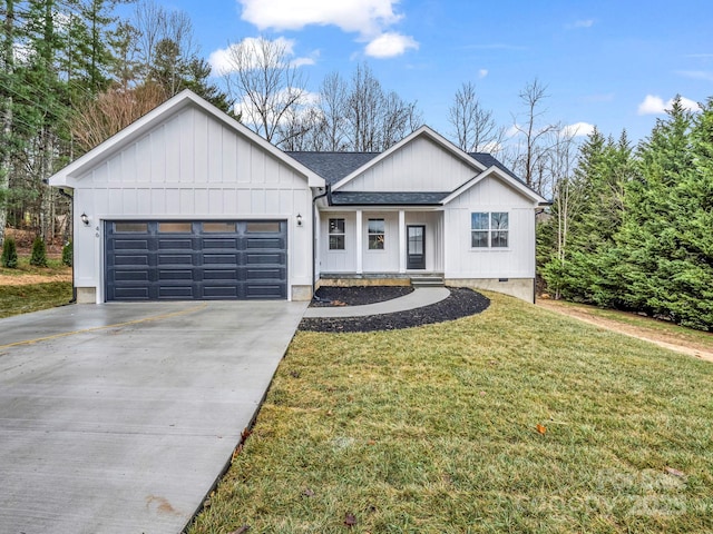 view of front of home featuring a garage and a front lawn