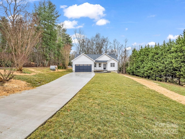 view of front of home with a front yard and a garage