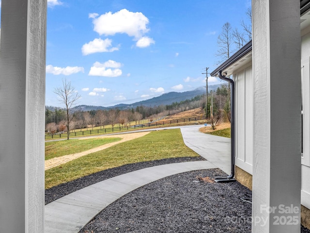 view of yard with a mountain view and a rural view