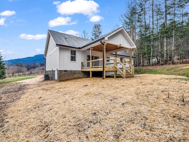 back of house with a wooden deck and central AC unit