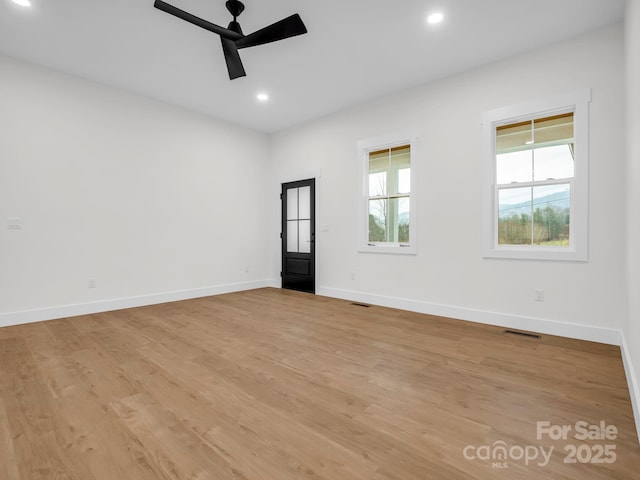 empty room featuring ceiling fan and light wood-type flooring