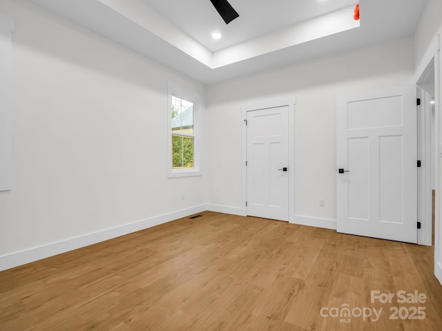 unfurnished bedroom featuring light wood-type flooring and ceiling fan