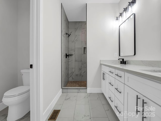 bathroom featuring an enclosed shower, vanity, and toilet