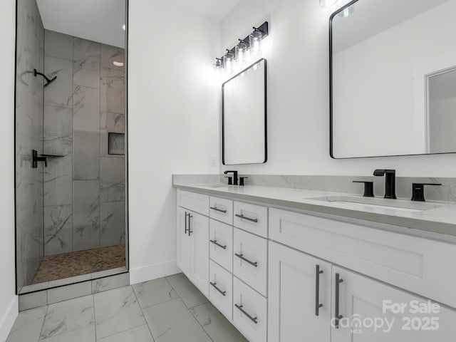 bathroom featuring a tile shower and vanity