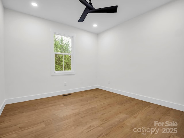 empty room with ceiling fan and hardwood / wood-style flooring