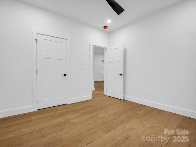 unfurnished bedroom with a closet, ceiling fan, and light hardwood / wood-style flooring