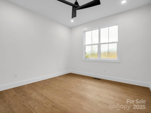 empty room featuring light hardwood / wood-style flooring and ceiling fan