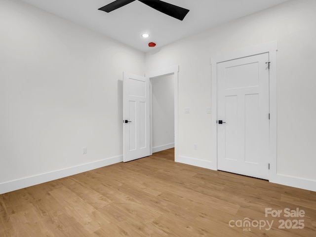 unfurnished bedroom with ceiling fan and light hardwood / wood-style floors