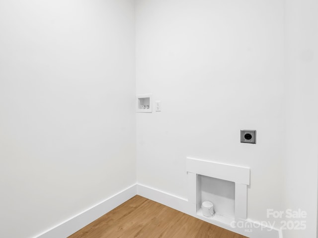 laundry area with hardwood / wood-style flooring, hookup for a washing machine, and hookup for an electric dryer